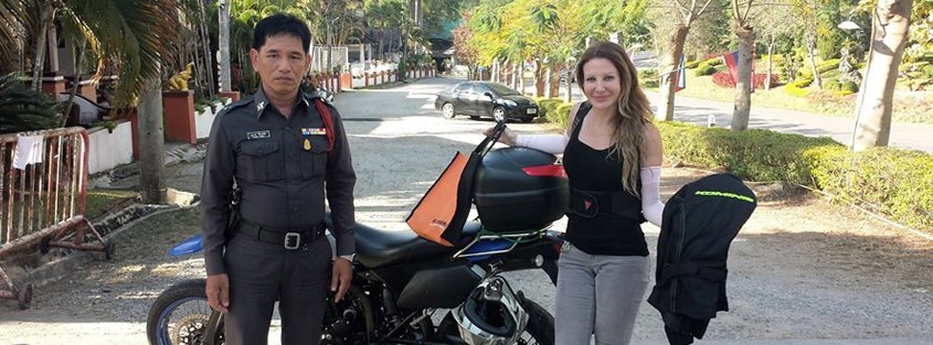 a motorcycle lady with a Thai policeman